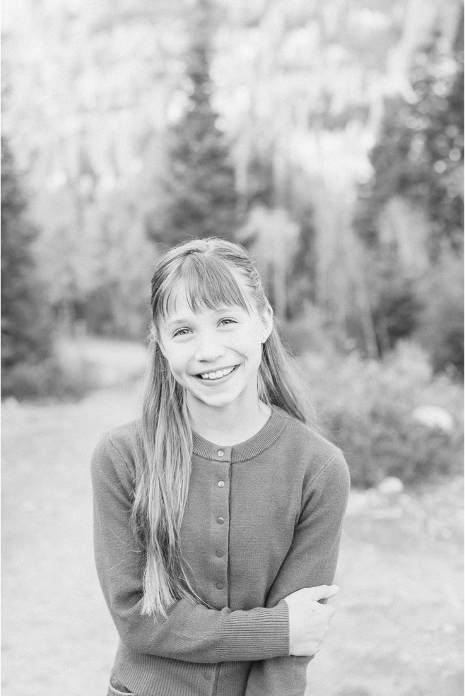 Black and white close-up portrait of a smiling girl outdoors