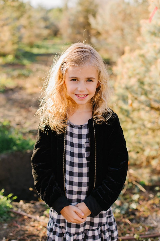 Girl in buffalo check at a Utah Christmas tree farm family session