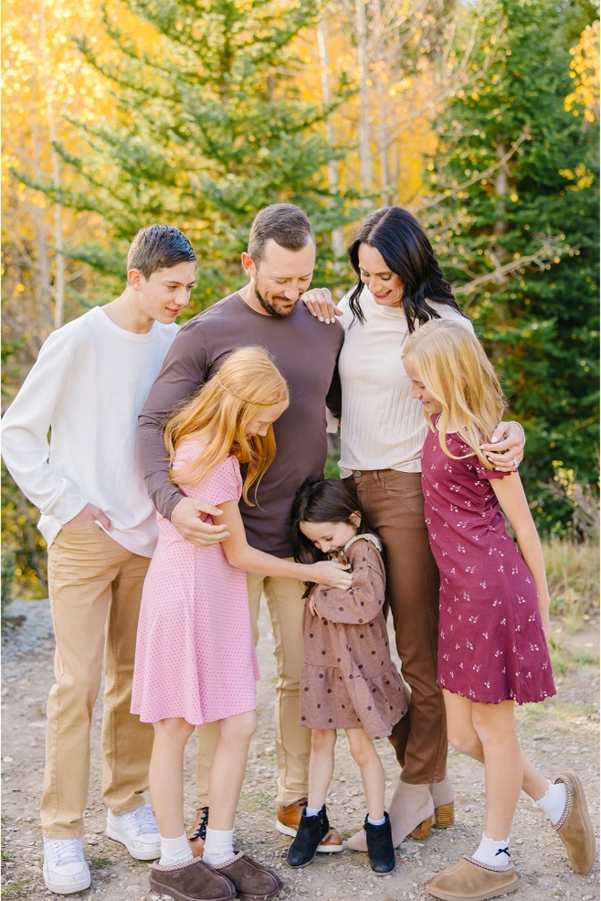 Family group hug with kids laughing during a Utah canyon family session