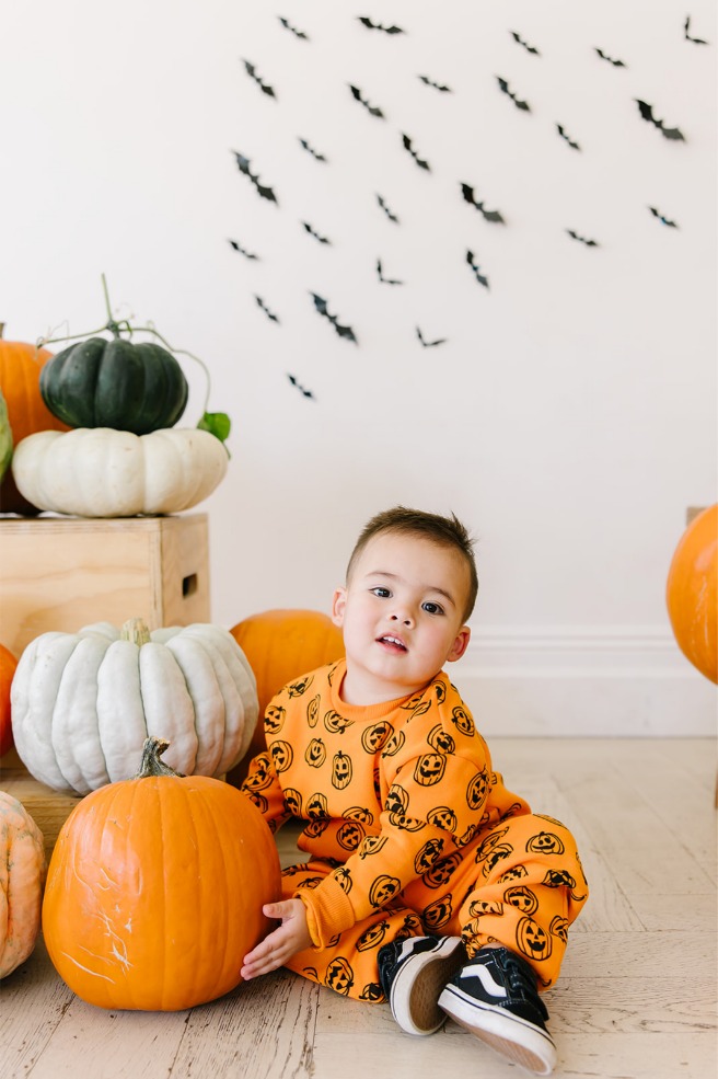 Close-up of smiling toddler boy at a Halloween mini session with Truly Photography